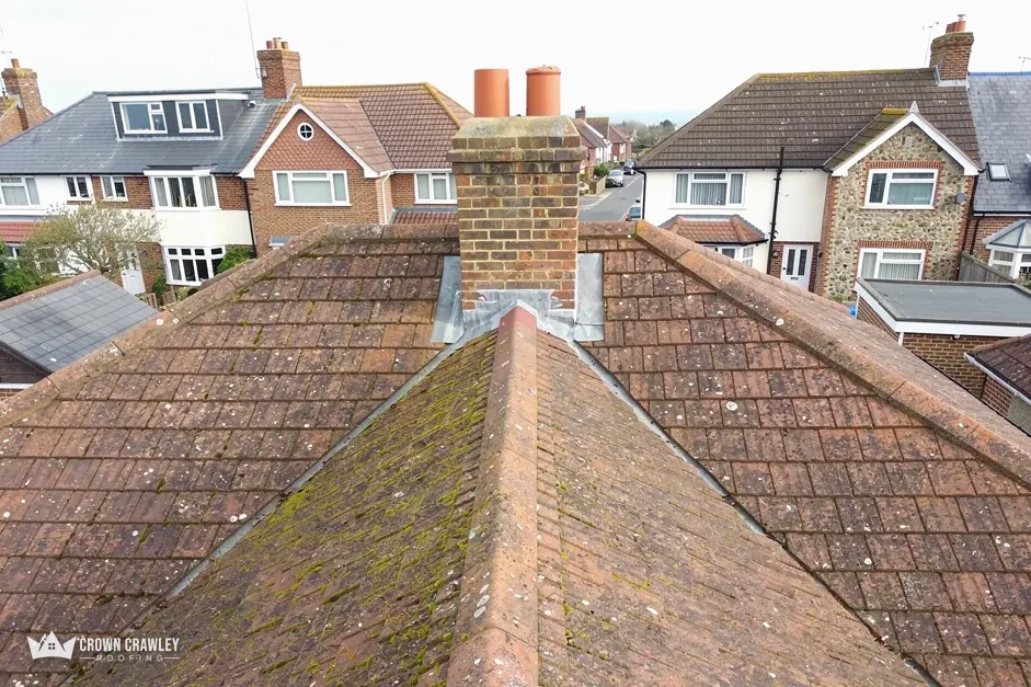 Hipped tiled roof with a chimney at the ridge