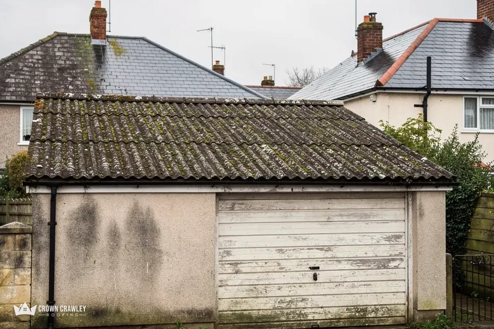 Mossy garage roof with a weathered timber door