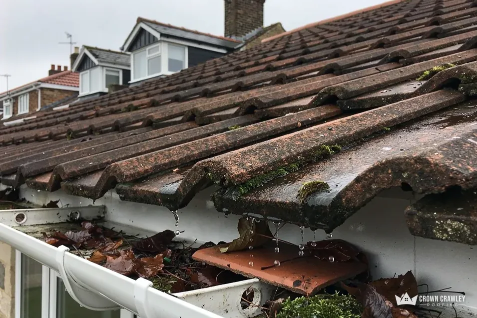Slipped tiles lying in a blocked gutter