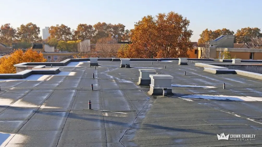 Large flat roof with vents and drainage seen from above
