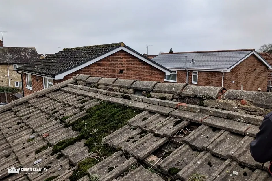 Aged concrete roof tiles with moss on the slope