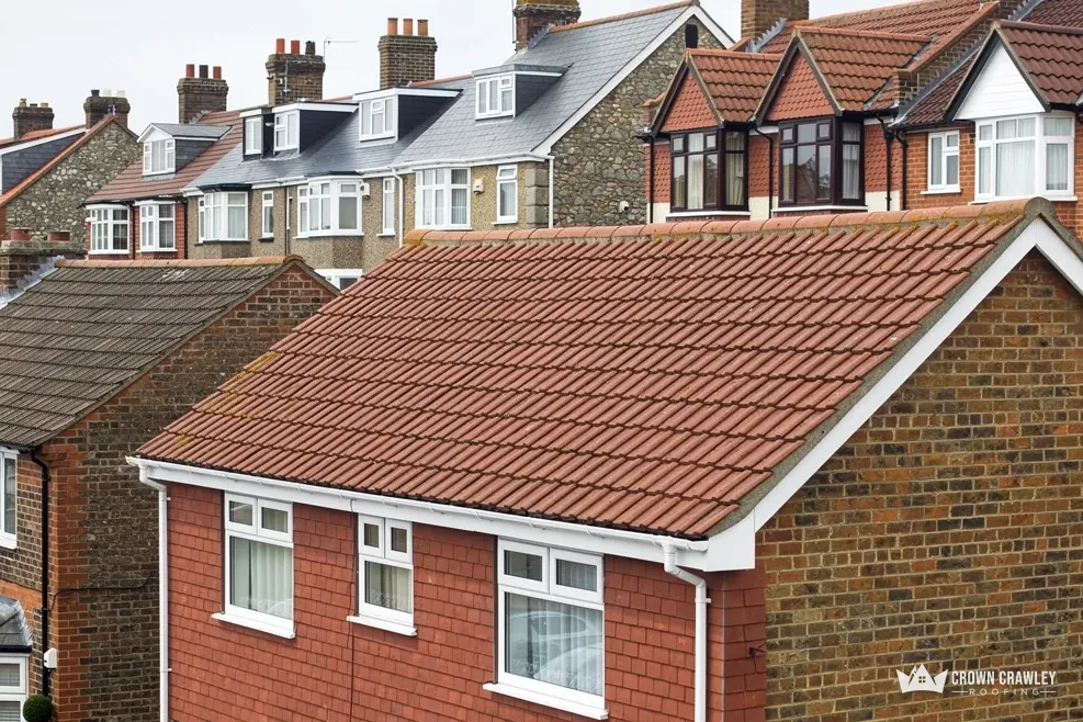 Red tiled roof on a pebbledash brick house