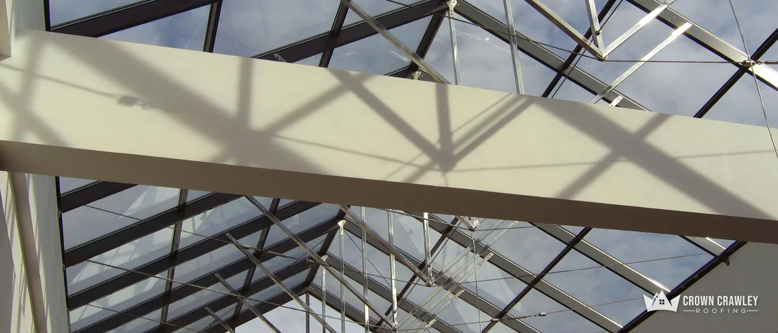 Steel and glass roof structure seen from below