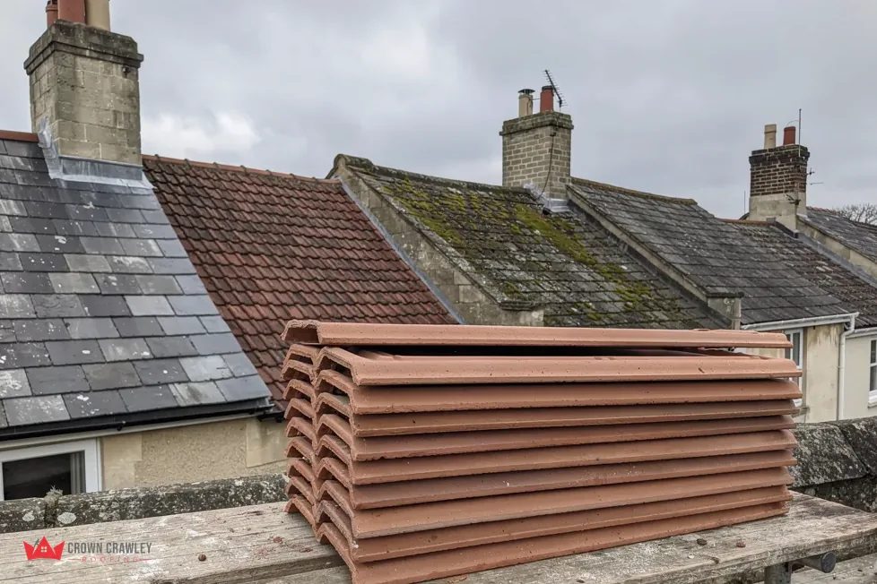 Stack of clay ridge and hip tiles on a flat roof
