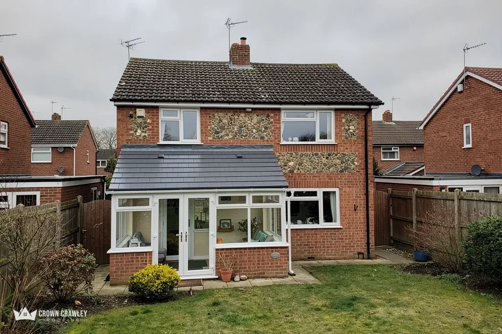 Brick house with a new conservatory roof in the garden