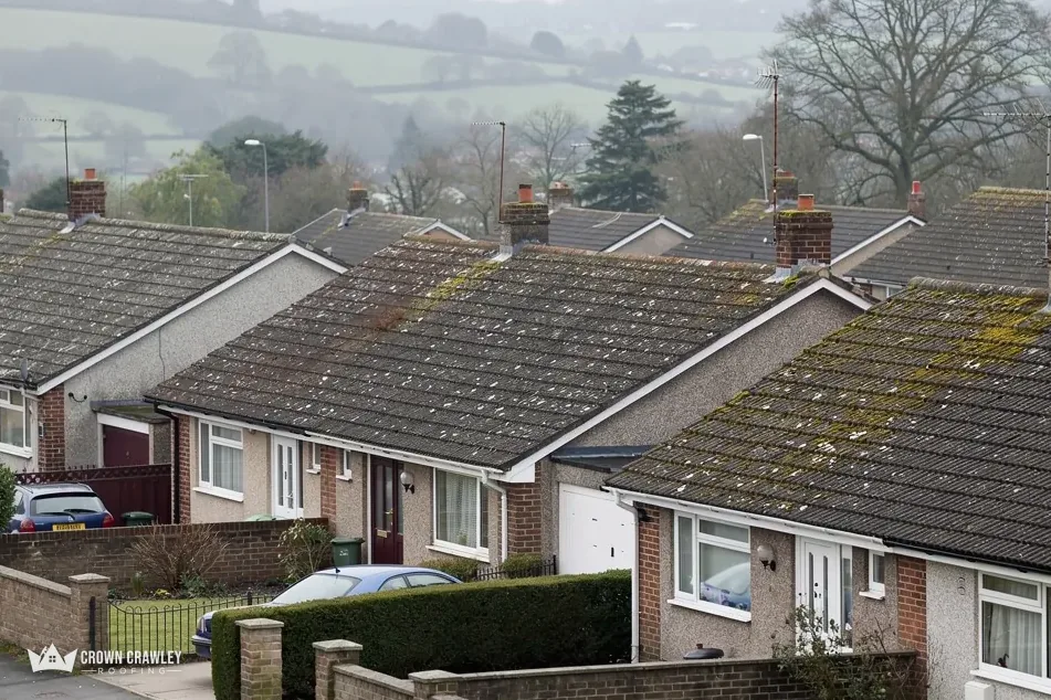 Terraced bungalows with grey tiled roofs along a cul-de-sac