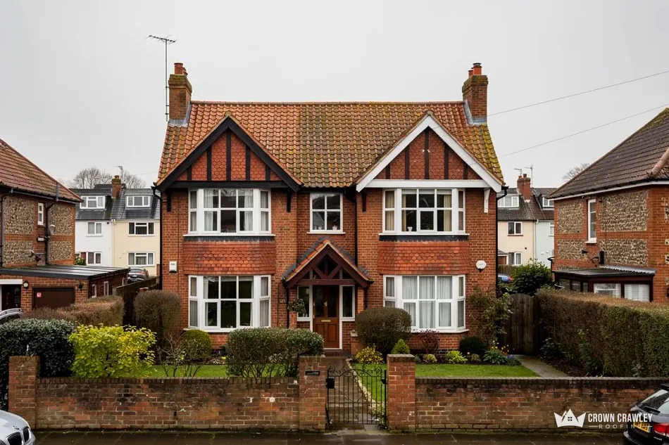 Victorian red brick villa with a clay tiled roof and bay windows