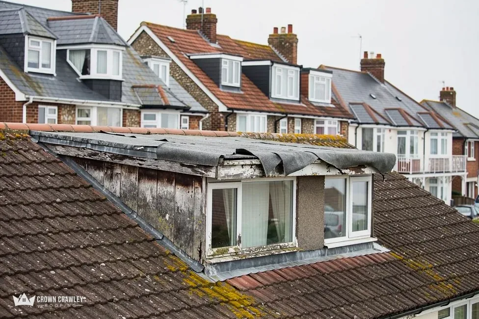Dormer window with worn lead cheeks on a tiled roof
