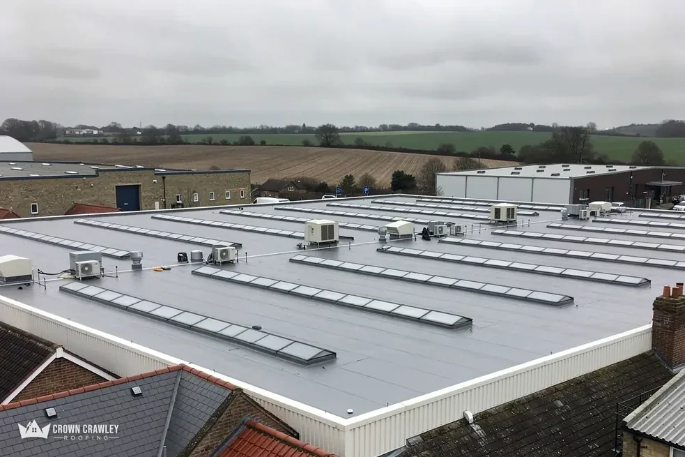 Large flat industrial roof with a line of rooflights